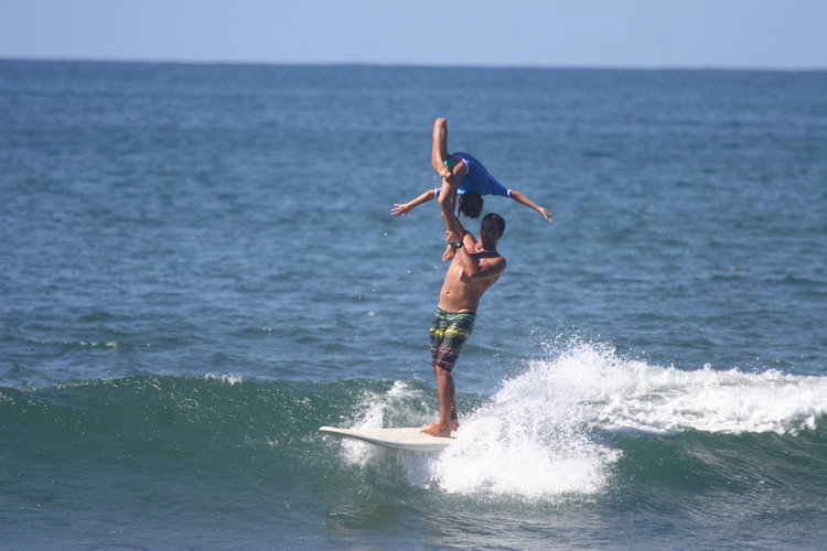 Father and daughter surfing